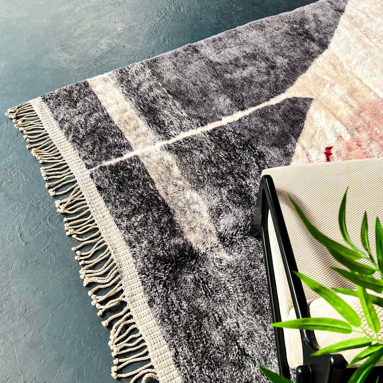 Create a cozy and inviting space with the Rosy Abstract Handwoven 100% Wool Beni Mrirt Rug, a beautiful Beni Ourain rug measuring 8.1 X 9.9 ft / 247 X 304 cm. This handwoven rug is made using traditional techniques and features a soft, plush texture.